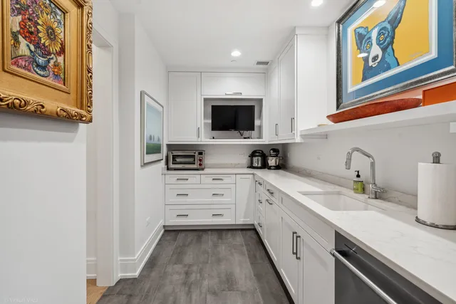 a kitchen with stainless steel appliances a sink stove and cabinets