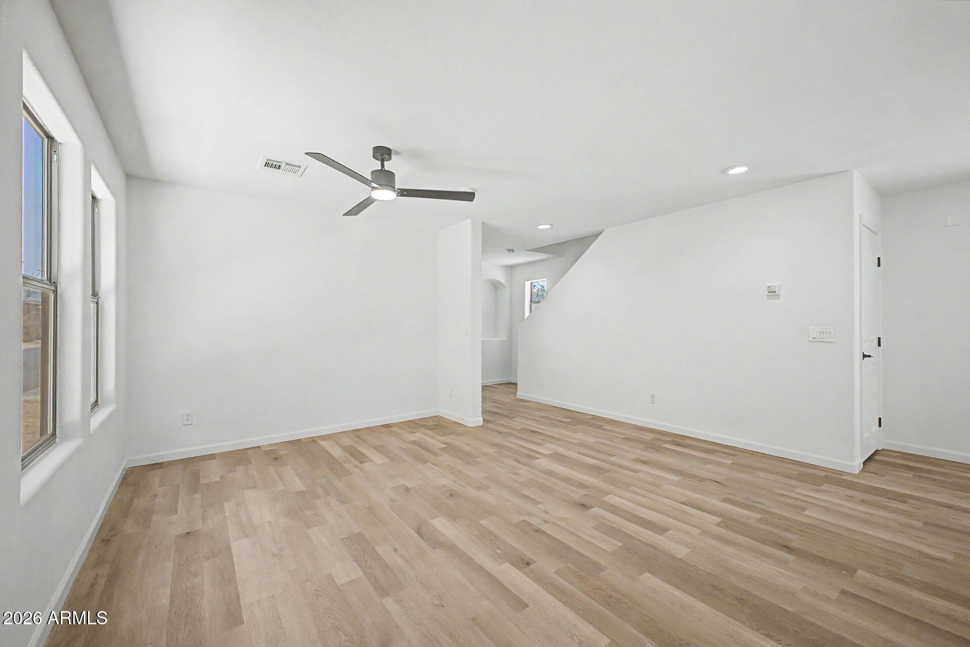 6452 West Ruth Avenue Glendale, AZ 85302 - Photo 7 of 35 an empty room with a ceiling fan and a window