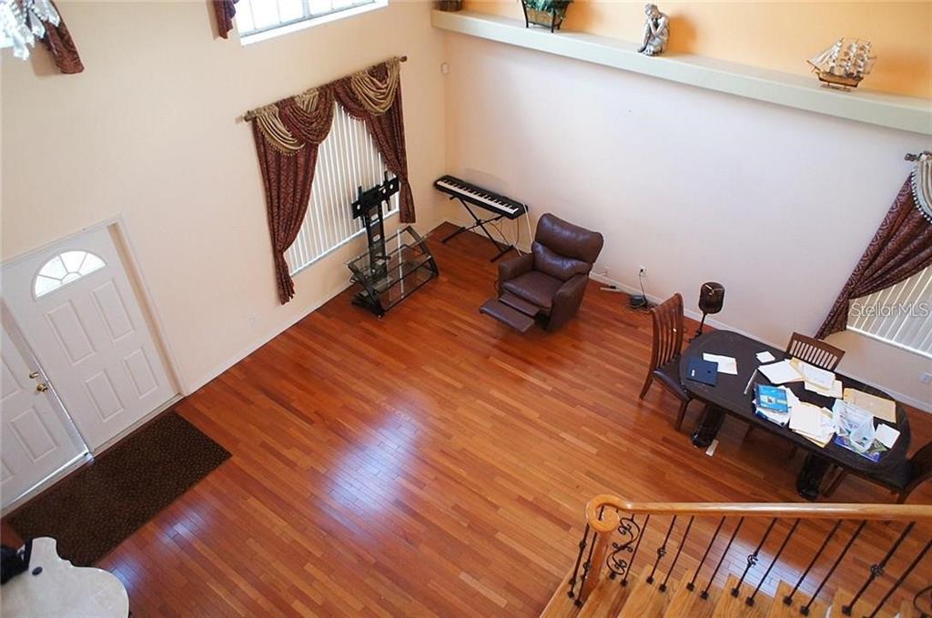 5948 Winchester Isle Road Orlando, FL 32829 - Photo 4 of 23 a room with wooden floor and furniture
