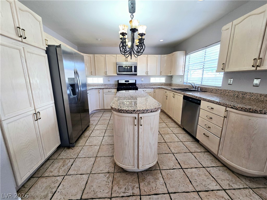 3759 Funston Way Las Vegas, NV 89129 - Photo 20 of 31 A well-appointed kitchen showcasing a central island and abundant cabinet space.