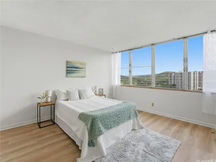 a bedroom with a large bed and a large window