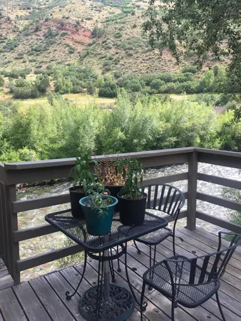 a view of balcony with two chairs and a table