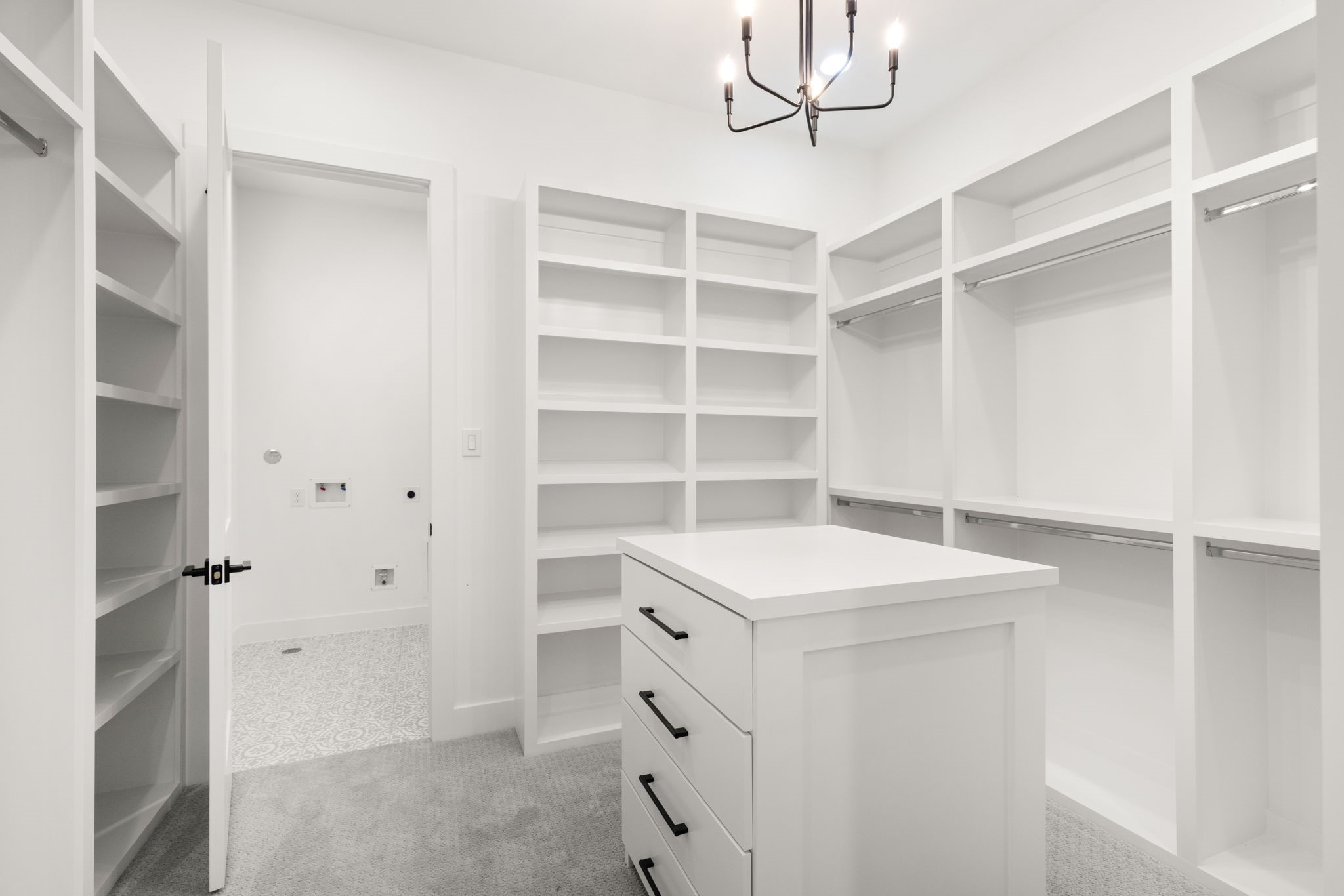 6209 Westcott Street Houston, TX 77007 - Photo 11 of 29 Primary closet #2 with center island, custom shelving, and direct access to the laundry room.
