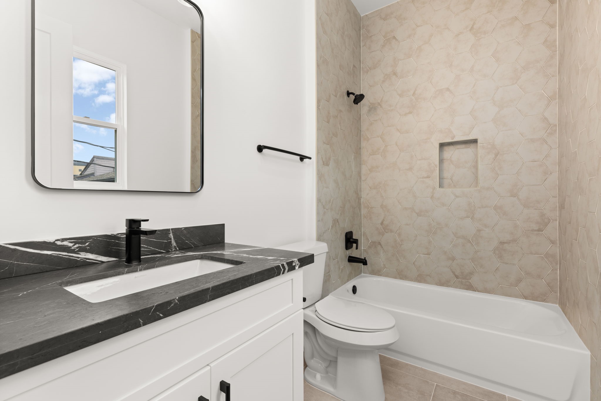 6209 Westcott Street Houston, TX 77007 - Photo 14 of 29 Elegant secondary full bath with sleek vanity, designer tile surround, and modern fixtures.