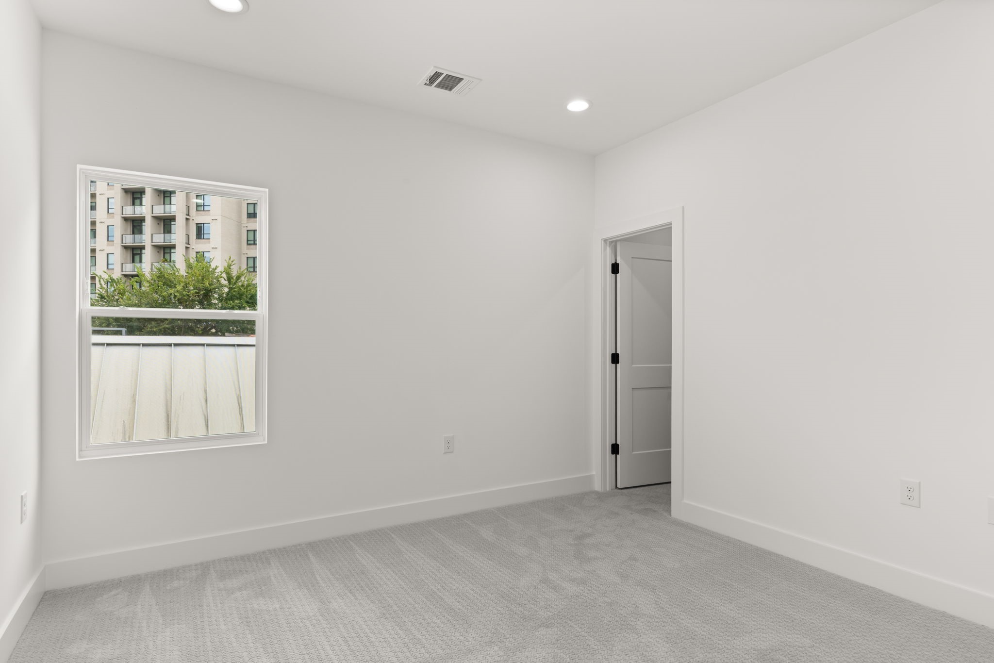 6209 Westcott Street Houston, TX 77007 - Photo 17 of 29 Secondary bedroom on the third floor with plush carpet, natural light, and private ensuite access.