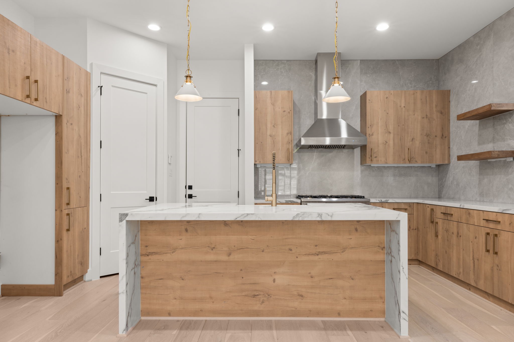 6209 Westcott Street Houston, TX 77007 - Photo 2 of 29 Designer kitchen with custom wood cabinetry, waterfall marble island, full-height stone backsplash, and pro-grade appliances.