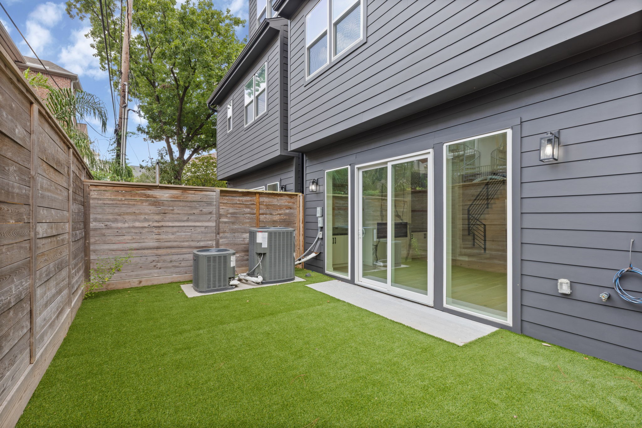 6209 Westcott Street Houston, TX 77007 - Photo 25 of 29 Rare private backyard with premium turf, offering a low-maintenance luxury retreat and seamless indoor-outdoor living.