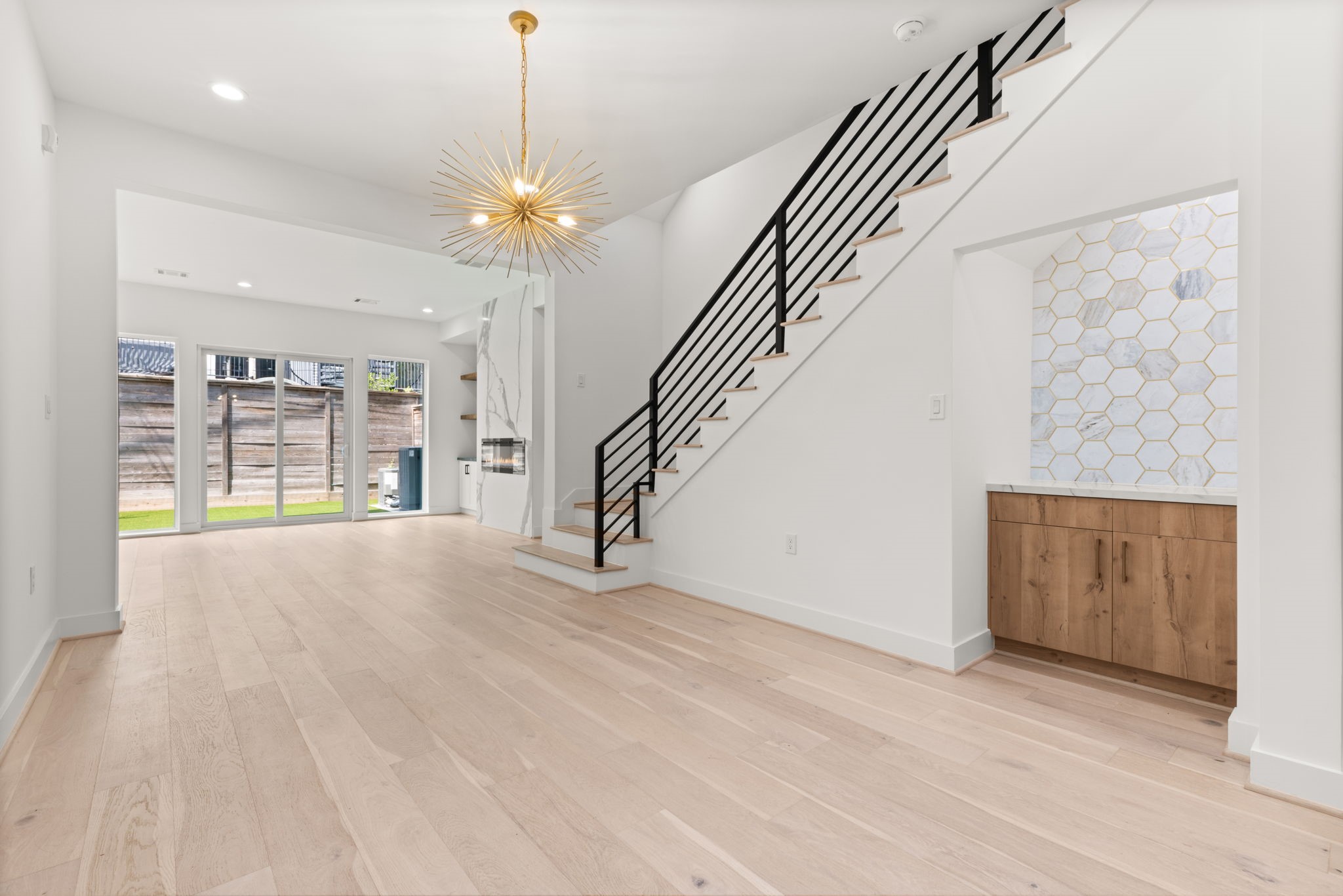 6209 Westcott Street Houston, TX 77007 - Photo 4 of 29 Elegant dining area with designer chandelier, custom wet bar, and open flow to the living room.