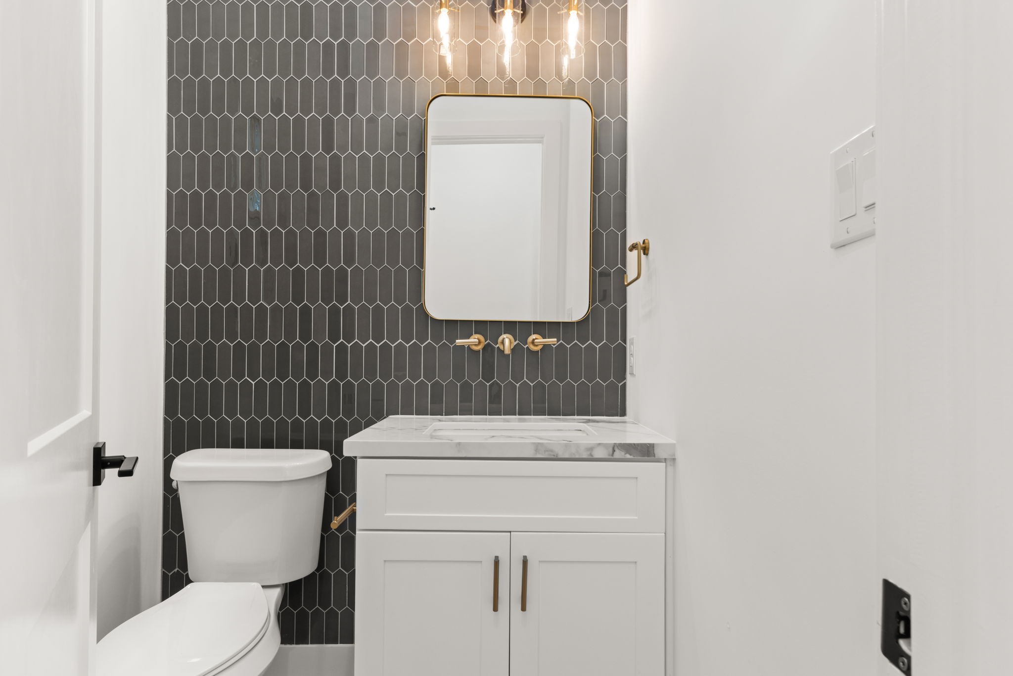 6209 Westcott Street Houston, TX 77007 - Photo 6 of 29 Chic first-floor powder bath with designer accent wall, modern vanity, and stylish fixtures.