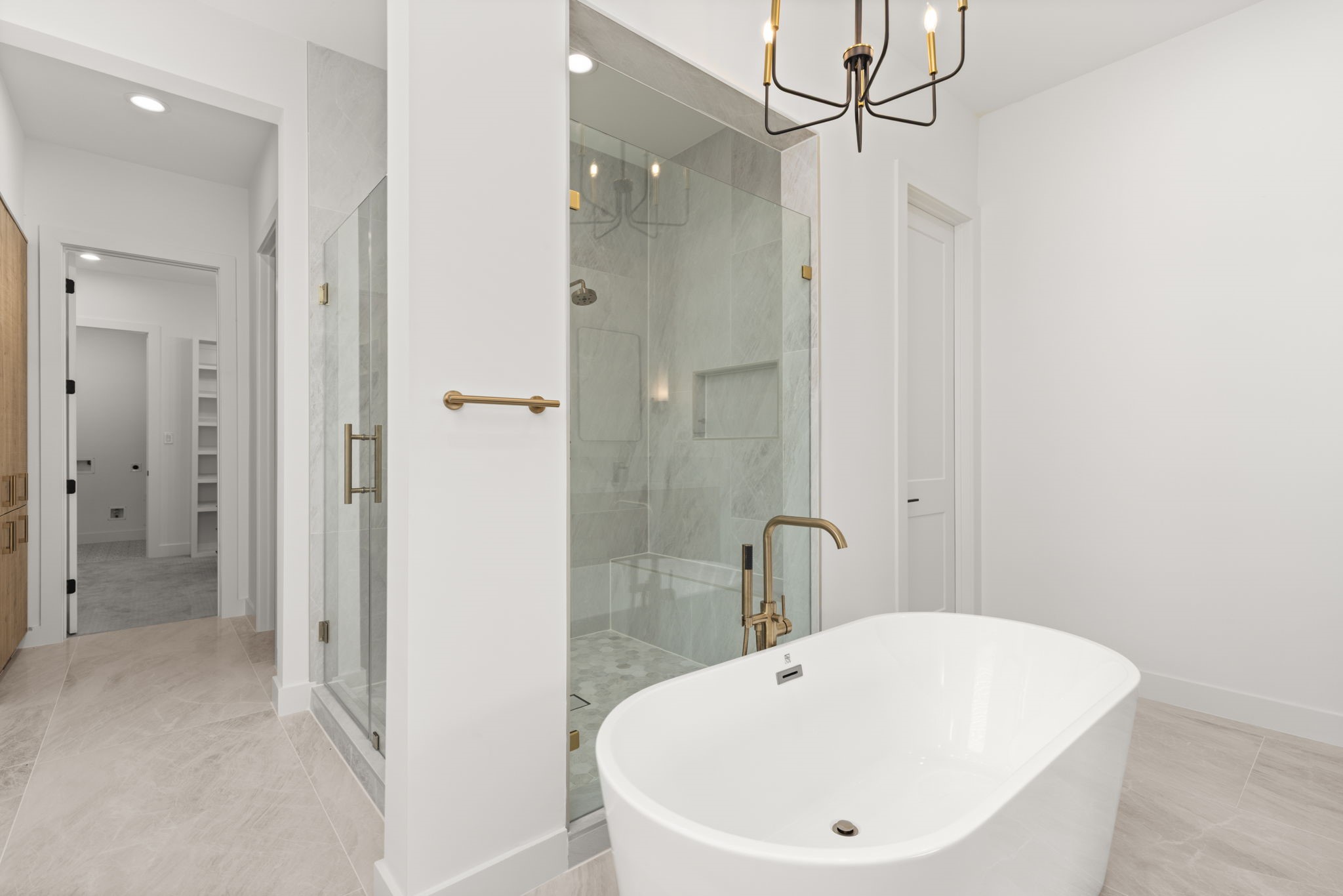 6209 Westcott Street Houston, TX 77007 - Photo 8 of 29 Luxury retreat primary bath with freestanding soaking tub, frameless glass shower, and dual vanity with designer lighting.