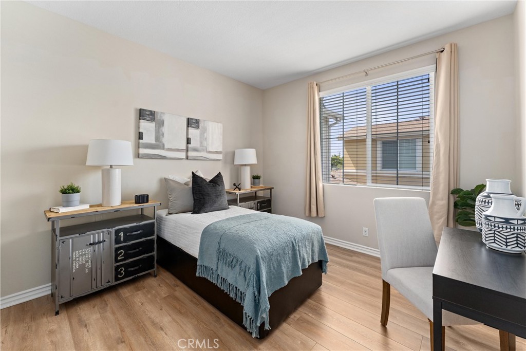 3229 Larkspur Street Tustin, CA 92782 - Photo 18 of 25 a bedroom with a bed and a table in it