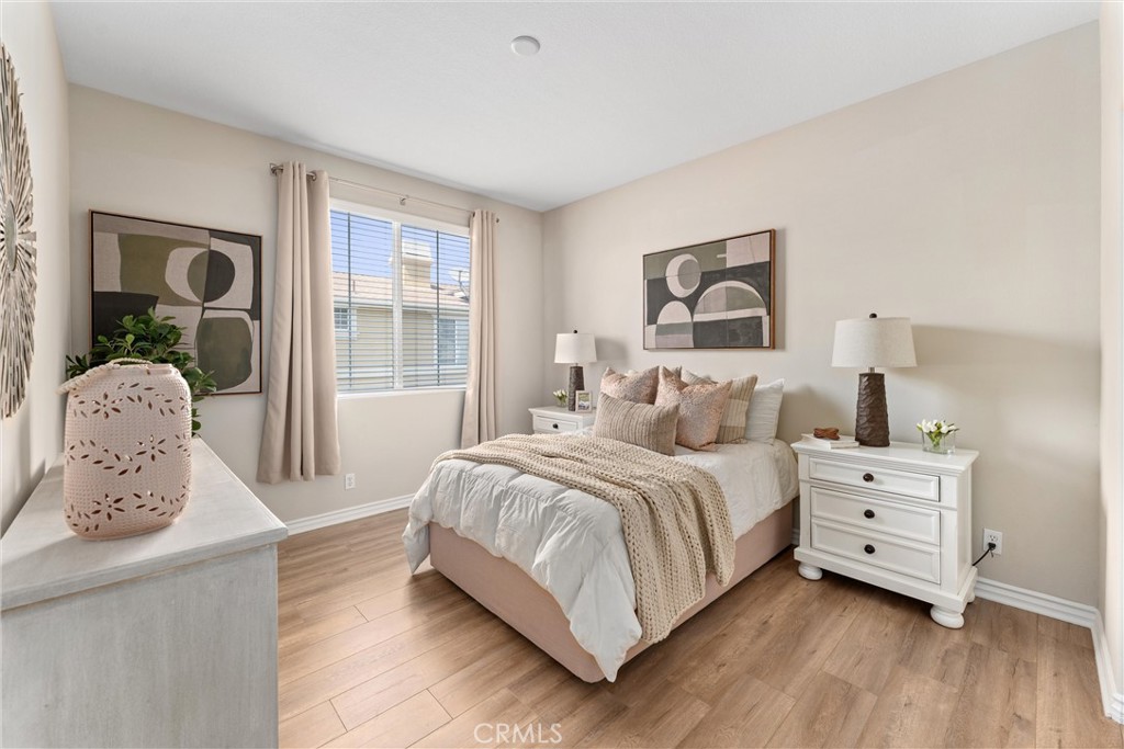 3229 Larkspur Street Tustin, CA 92782 - Photo 20 of 25 a bedroom with a bed and a painting on the wall