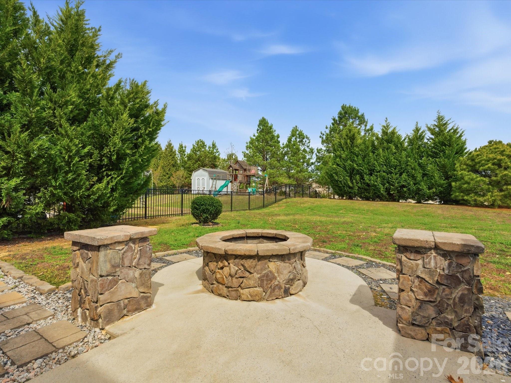 a view of a garden with an outdoor seating