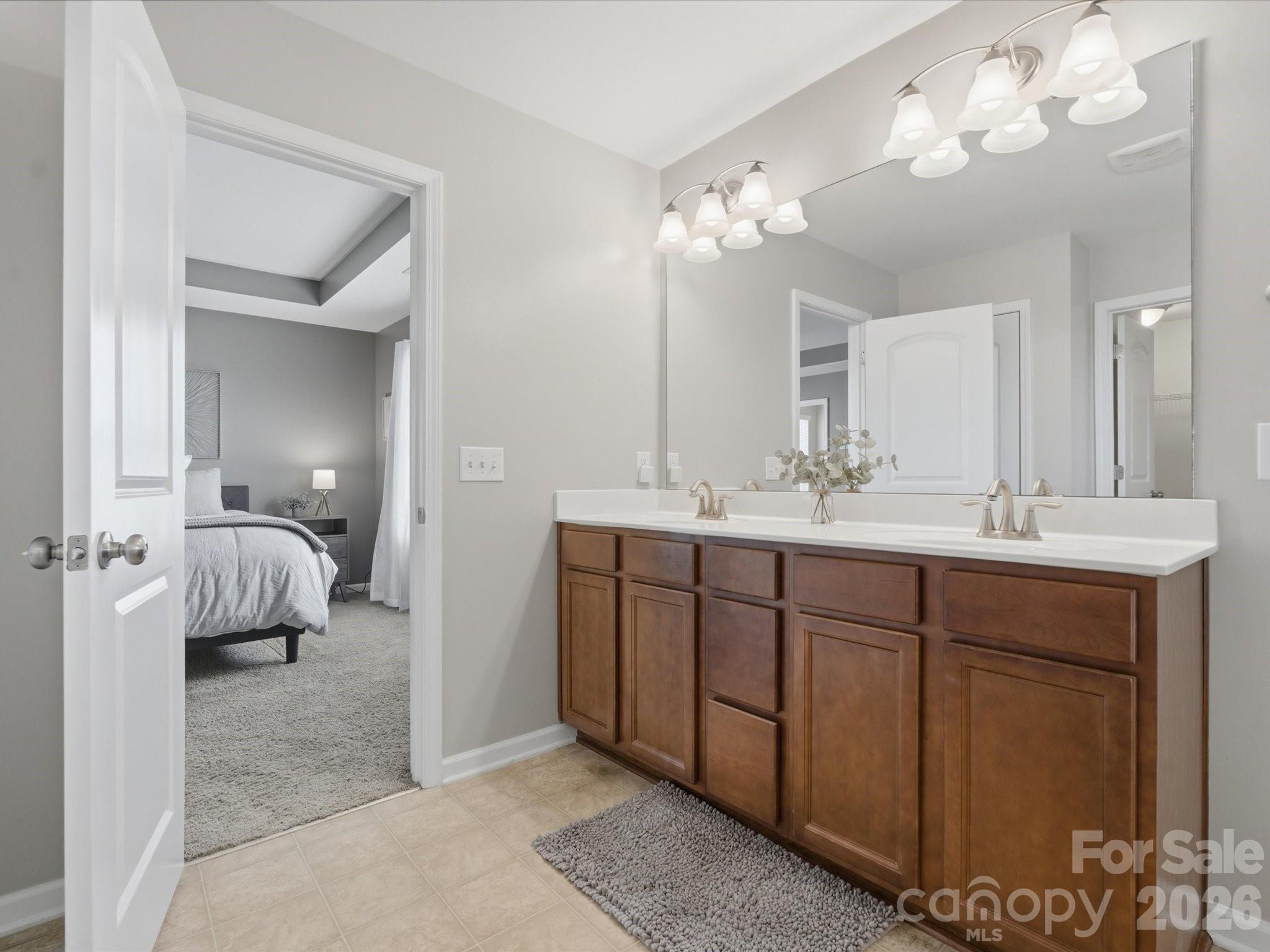 79321 Ridgehaven Road Lancaster, SC 29720 - Photo 21 of 35 a spacious en suite bathroom with a double vanity sink and a mirror