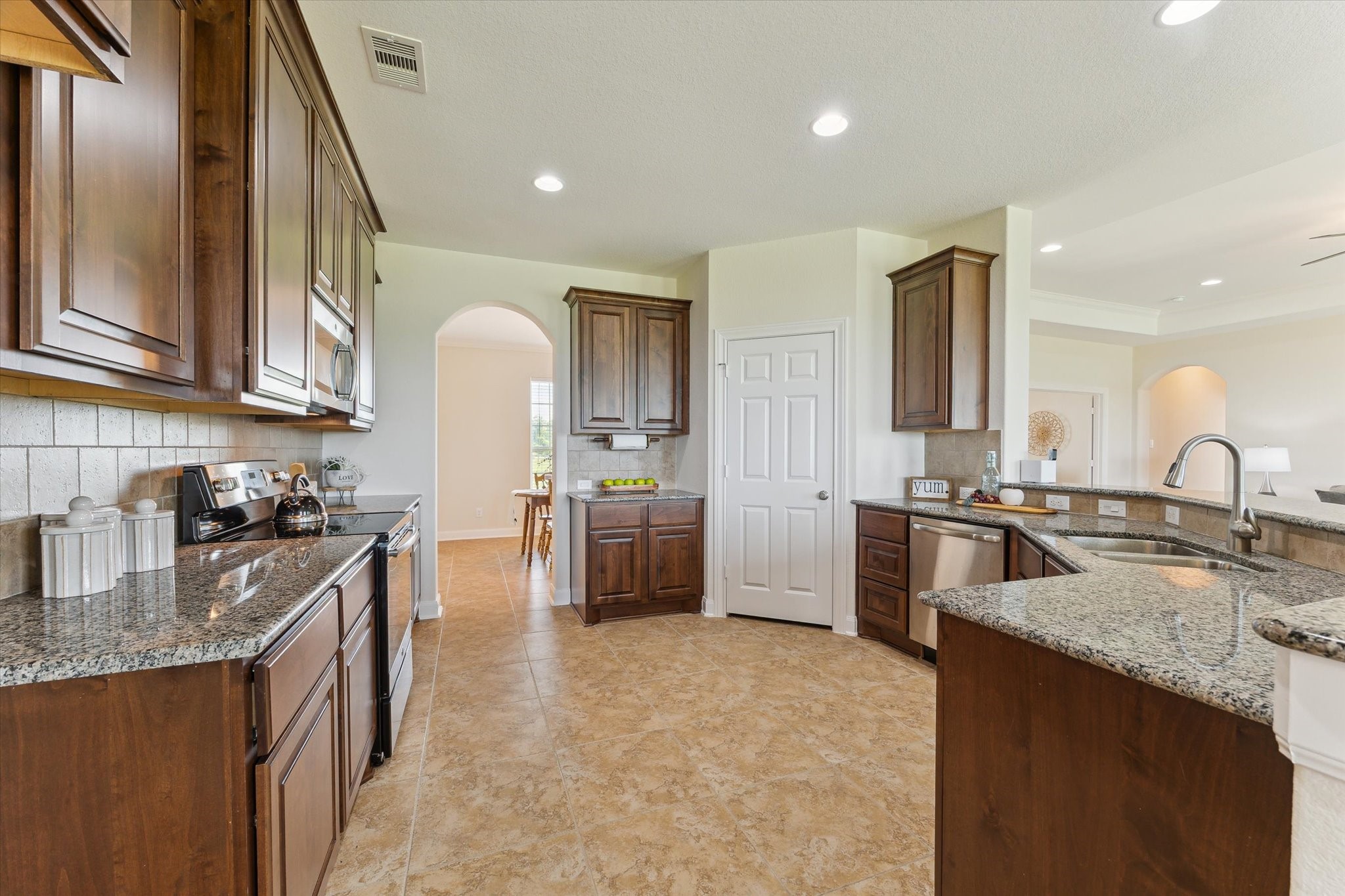 3850 Farm To Market 2917 Alvin, TX 77511 - Photo 11 of 30 a kitchen with stainless steel appliances granite countertop a sink stove and refrigerator