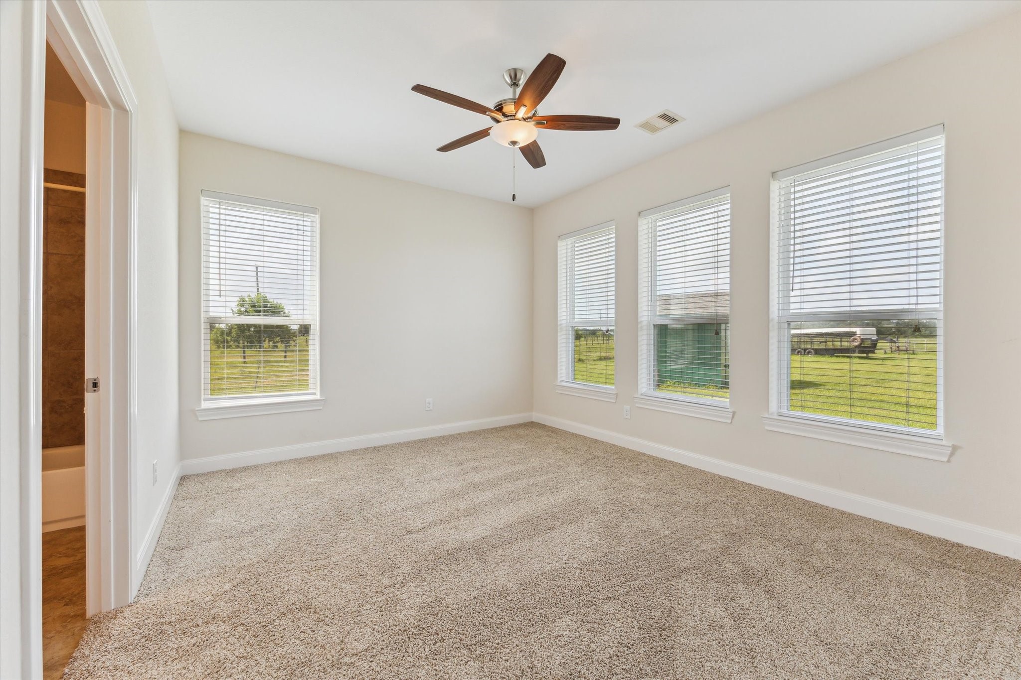 3850 Farm To Market 2917 Alvin, TX 77511 - Photo 16 of 30 a view of an empty room with a window and a ceiling fan