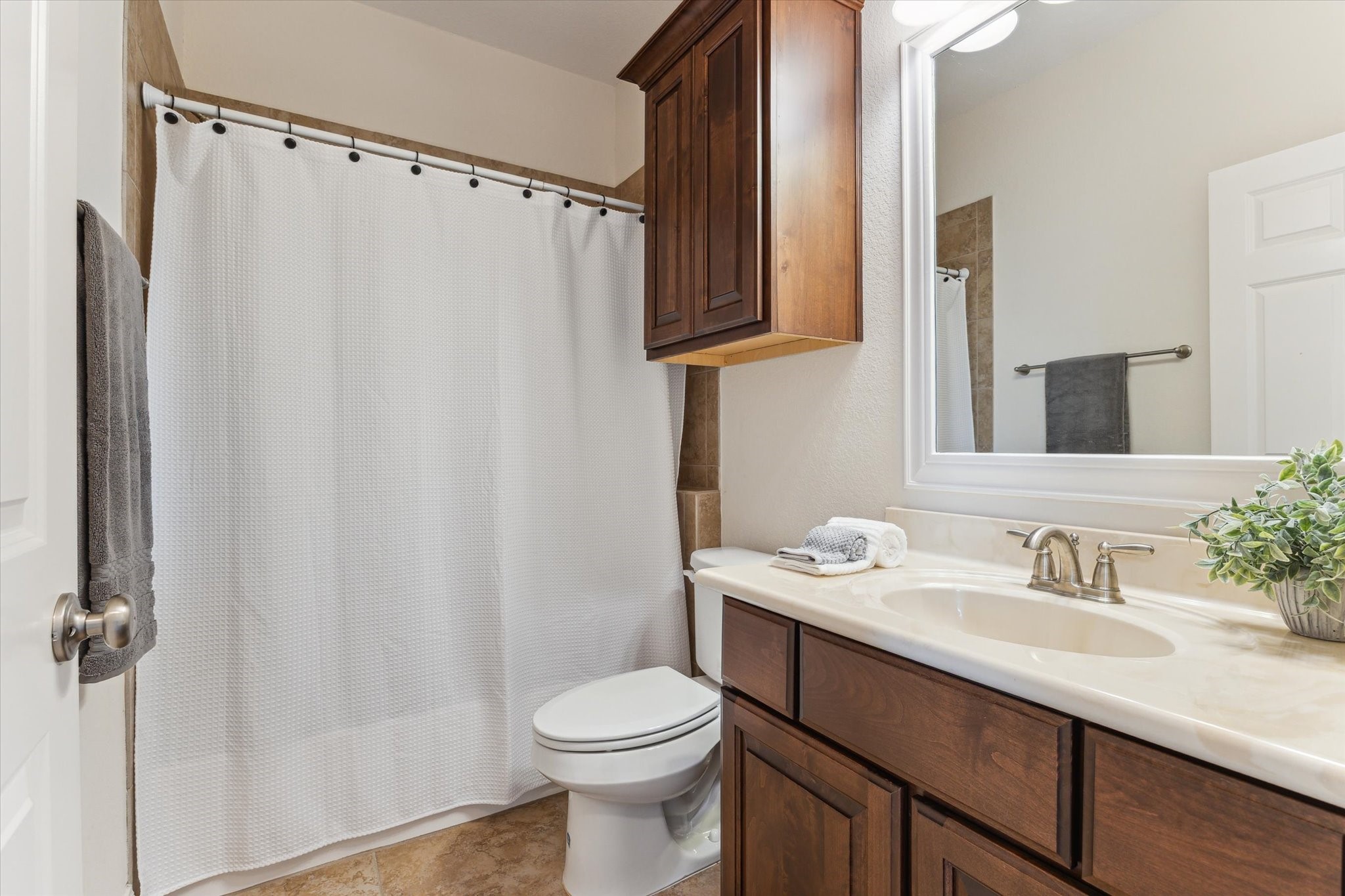 3850 Farm To Market 2917 Alvin, TX 77511 - Photo 19 of 30 a bathroom with a sink a toilet and shower curtain