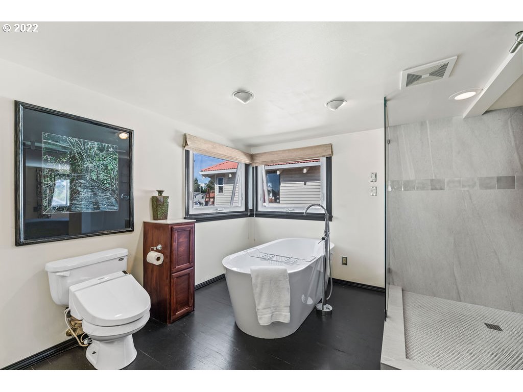 205 North Bridgeton Road, Unit W09 Portland, OR 97217 - Photo 25 of 32 a bathroom with a toilet sink a mirror and shower