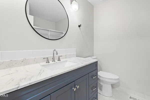 a bathroom with a glass shower door