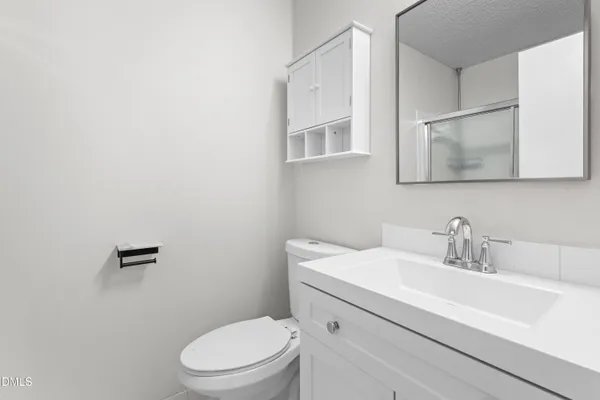 a bathroom with a glass shower door
