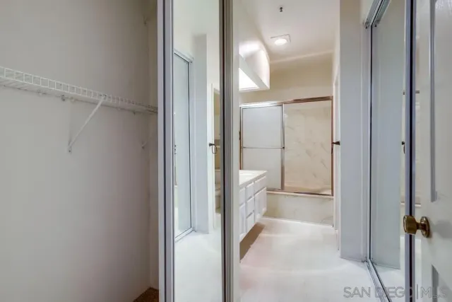 a bathroom with a glass shower door