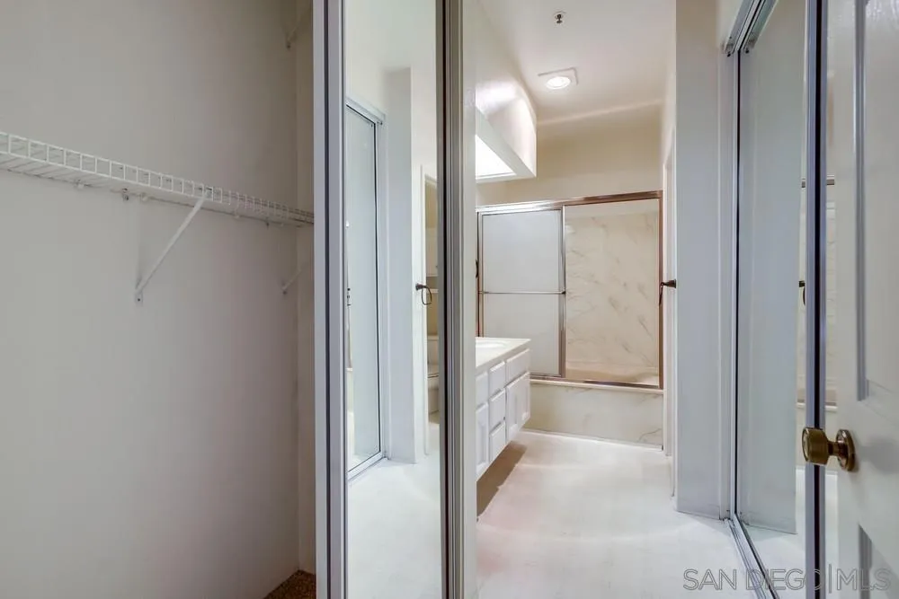 5865 Friars Road, Unit 3113 San Diego, CA 92110 - Photo 15 of 39 a bathroom with a glass shower door