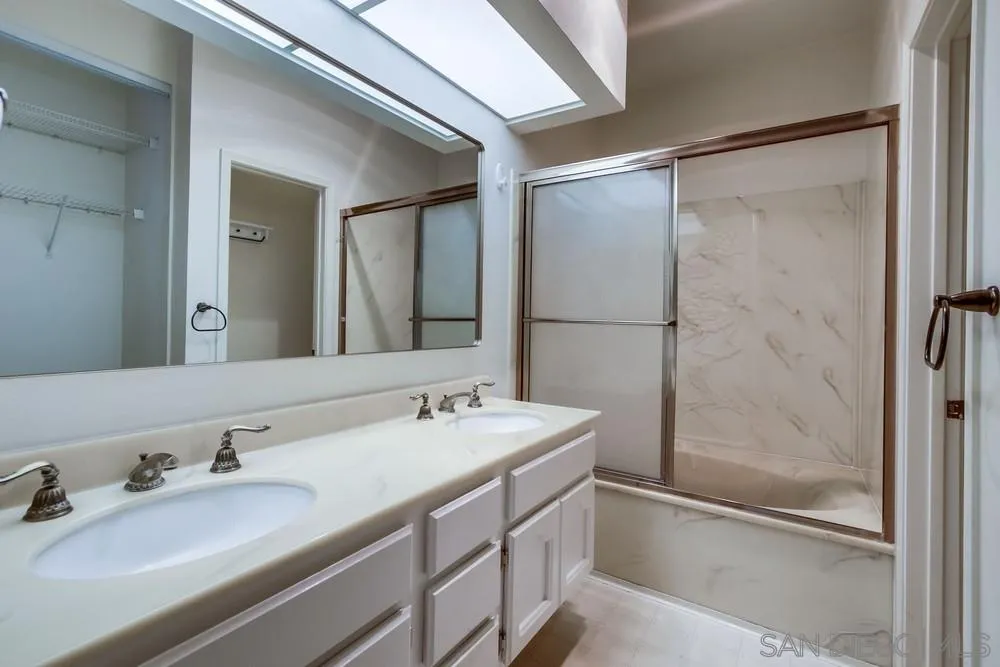 5865 Friars Road, Unit 3113 San Diego, CA 92110 - Photo 17 of 39 a bathroom with a granite countertop sink mirror and double