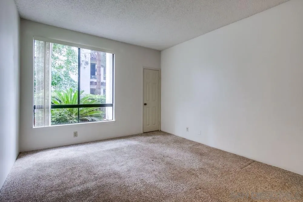 5865 Friars Road, Unit 3113 San Diego, CA 92110 - Photo 20 of 39 an empty room with windows
