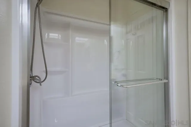 a bathroom with a glass shower door