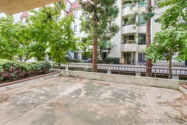 a view of residential house with stairs and trees around