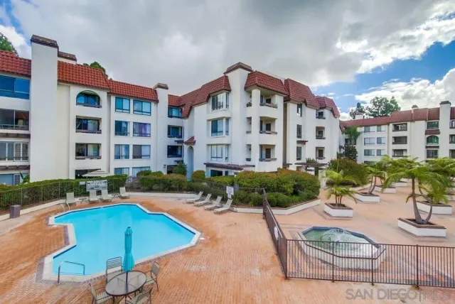 a view of a building with swimming pool and sitting area