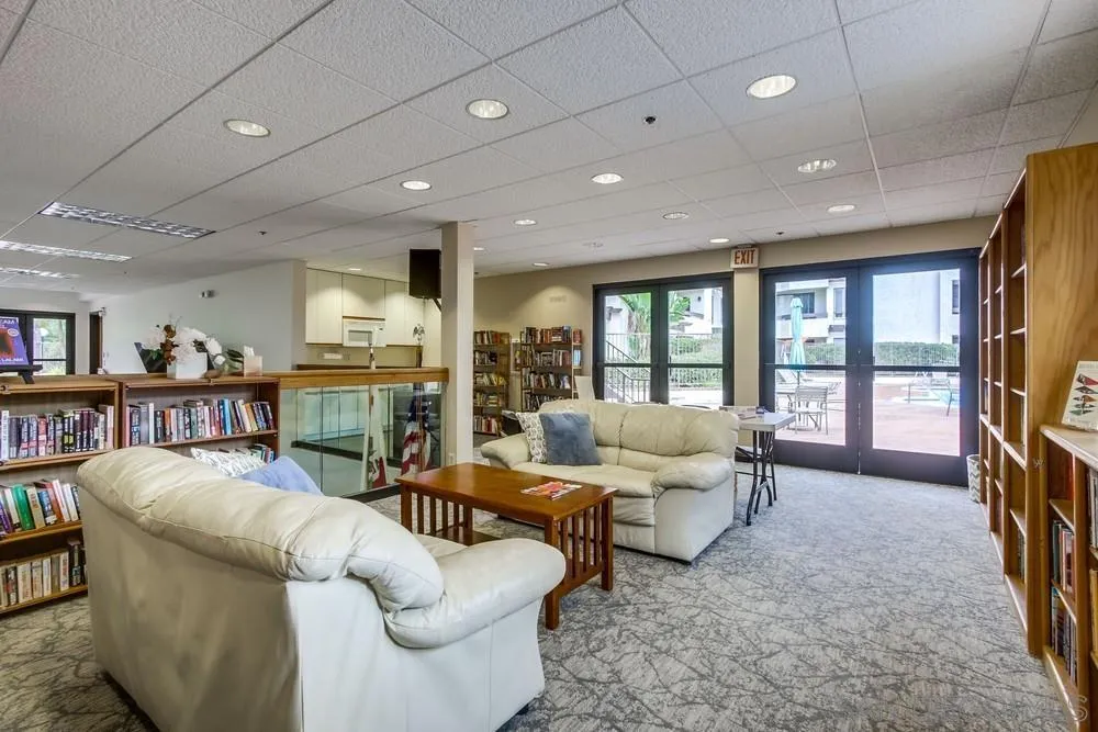 5865 Friars Road, Unit 3113 San Diego, CA 92110 - Photo 34 of 39 a living room with furniture and a flat screen tv