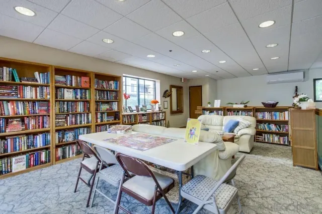 a living room with lots of furniture and a book shelf