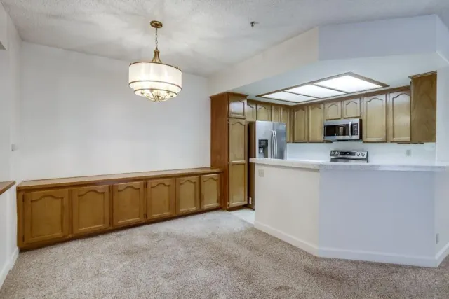 a view of a kitchen with microwave and cabinets