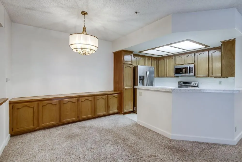 5865 Friars Road, Unit 3113 San Diego, CA 92110 - Photo 6 of 39 a view of a kitchen with microwave and cabinets