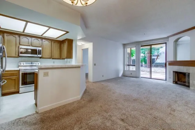 a view of a kitchen with a sink oven cabinets and a window
