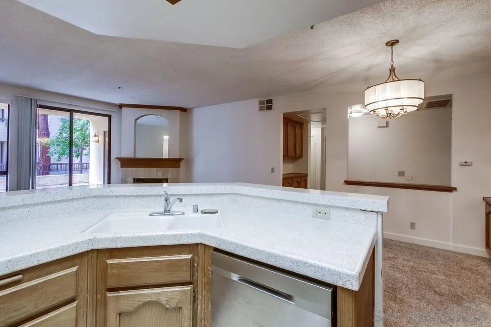 5865 Friars Road, Unit 3113 San Diego, CA 92110 - Photo 10 of 39 a kitchen with a sink a counter space and cabinets