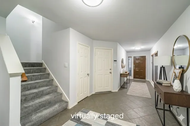 a view of a hallway with entryway and couches