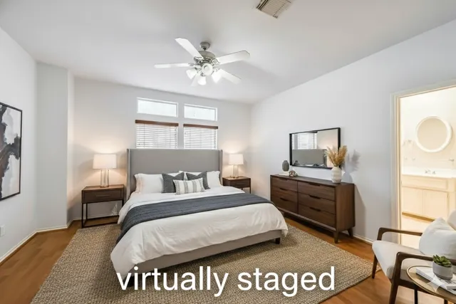 a bedroom with a large bed and a chandelier