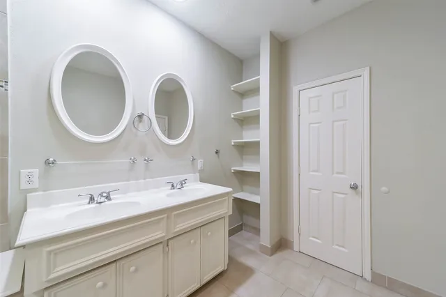 a bathroom with a double vanity sink and a mirror