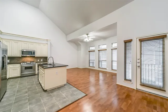 a kitchen with stainless steel appliances granite countertop a sink stove and cabinets