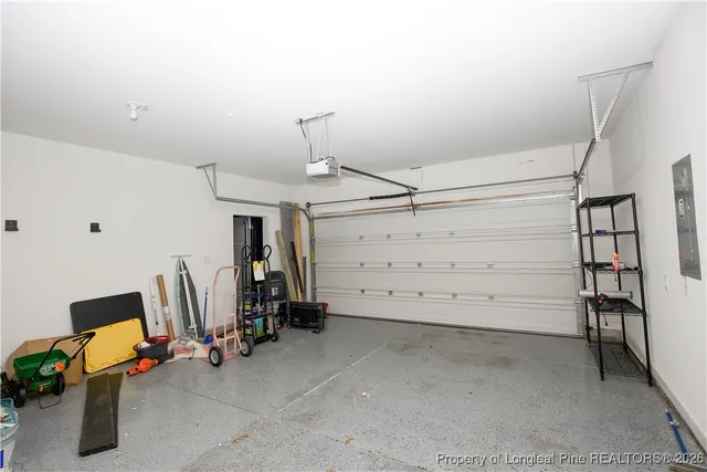 a dinning room with a ceiling fan and a rug