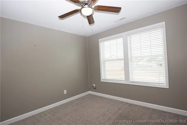 a bathroom with a toilet and a shower curtain