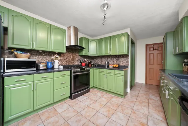 a kitchen with a sink cabinets and a stove top oven