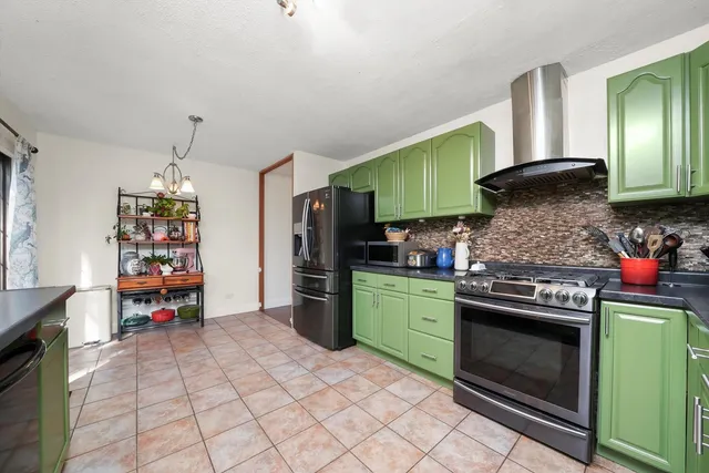 a kitchen with stainless steel appliances a stove and cabinets