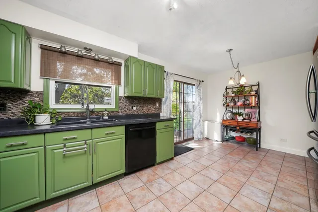 a kitchen that has a sink and a stove in it