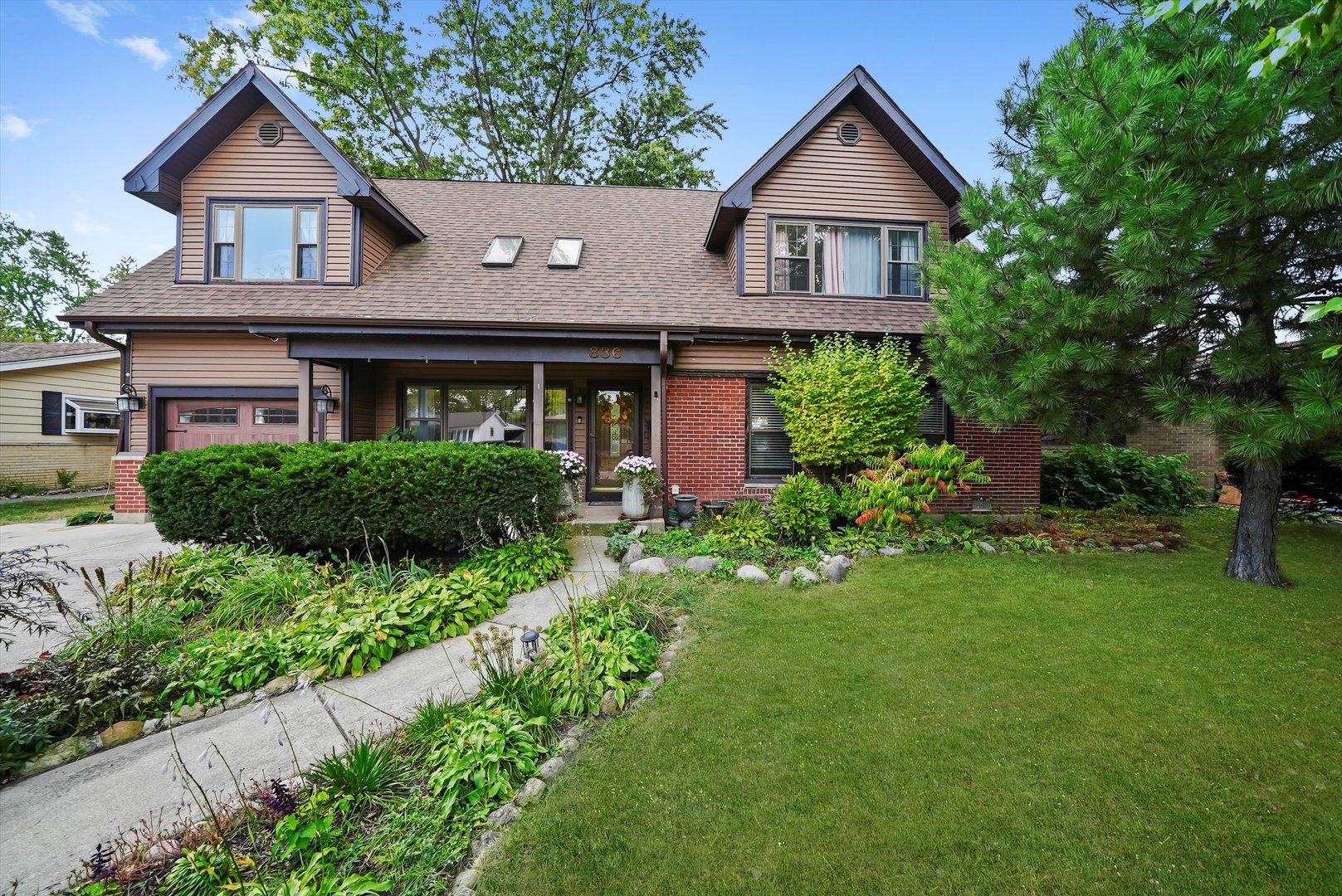 836 Bonita Avenue Elk Grove Village, IL 60007 - Photo 2 of 41 a front view of a house with a yard and potted plants