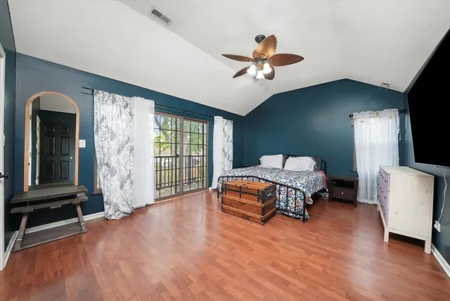 a bedroom with a large bed and a window