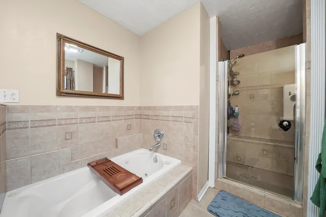 a bathroom with a tub sink and shower