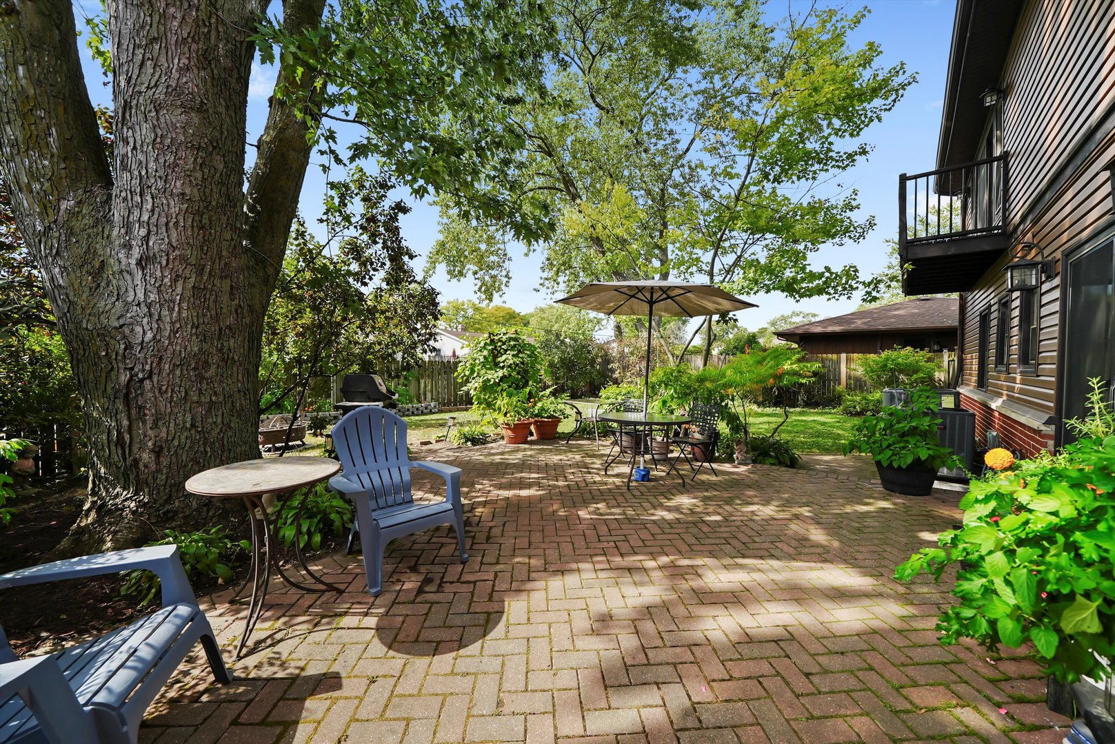 836 Bonita Avenue Elk Grove Village, IL 60007 - Photo 37 of 41 a view of a patio with table and chairs potted plants and large tree